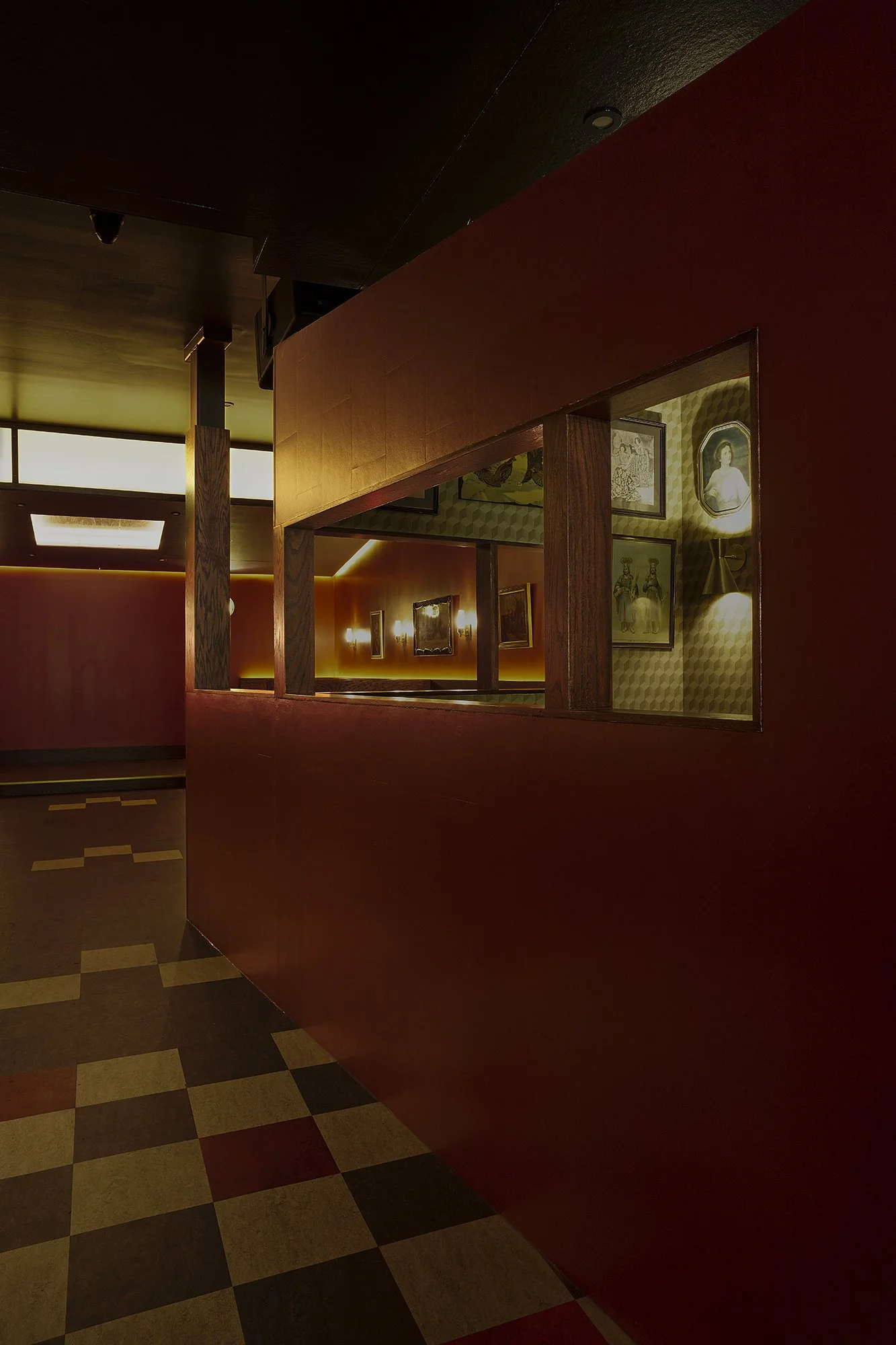 Gazebo interior inside Mr. Nancy’s bar, featuring a red partition structure with warm lighting that creates an intimate seating zone.