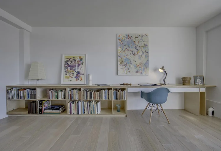Live-work studio with a long desk and bookshelf