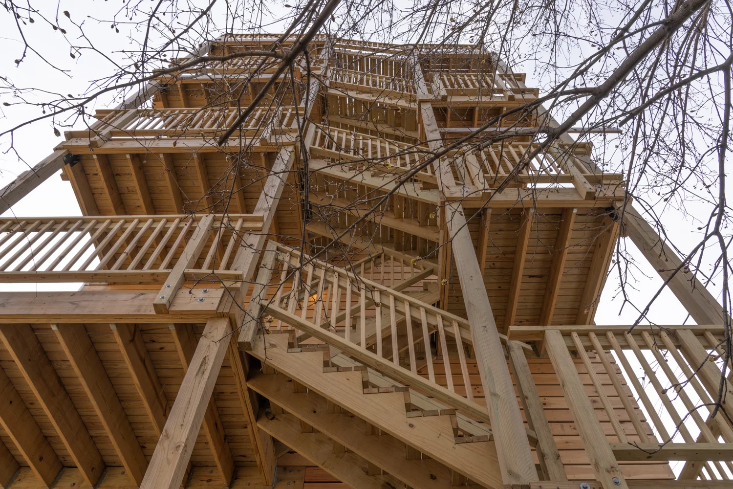 Exterior view of the multi-story wooden stair structure at Swift Street Residences, showing exposed framing, railings, and vertical circulation.