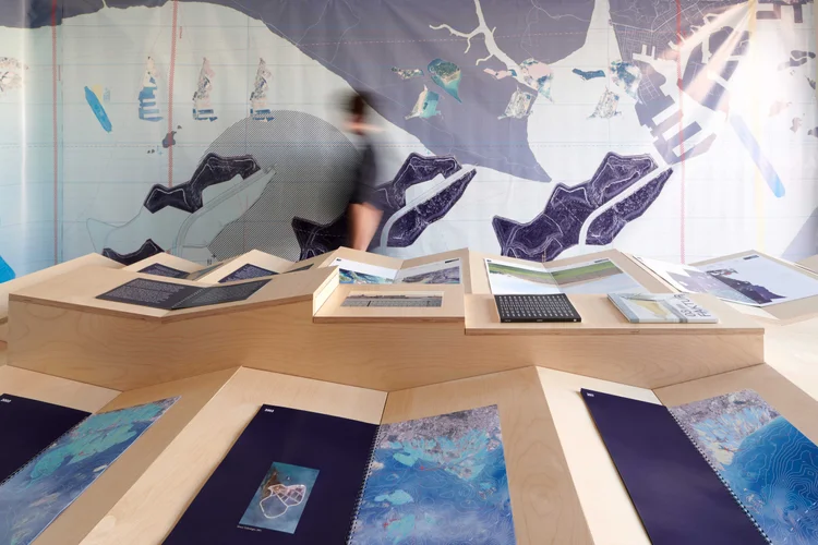 Exhibition tables with maps and prints