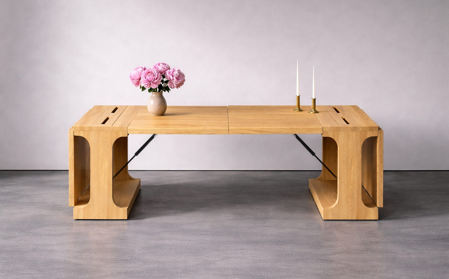 Folding Kenzan dining table fully extended in light maple wood, with integrated linear openings, ikebana flowers, and candle setting