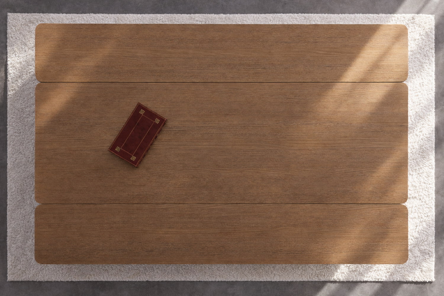 Folding Elevator dining table shown in its open configuration in light maple wood on a textured rug