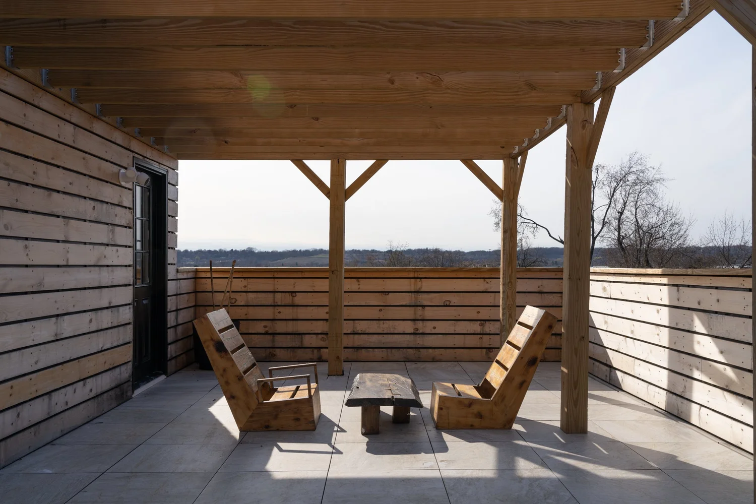 Shared rooftop garden at Swift Street Residences, designed for daily outdoor use with views toward the Hudson River.
