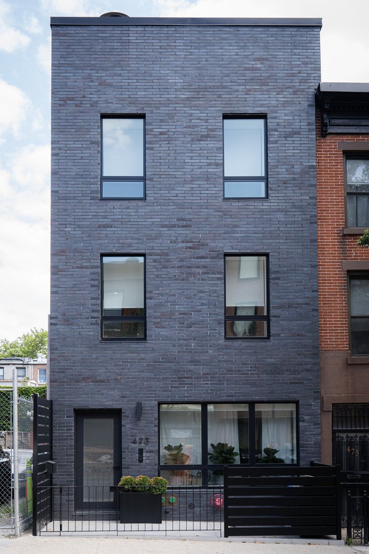 Dark brick townhouse facade
