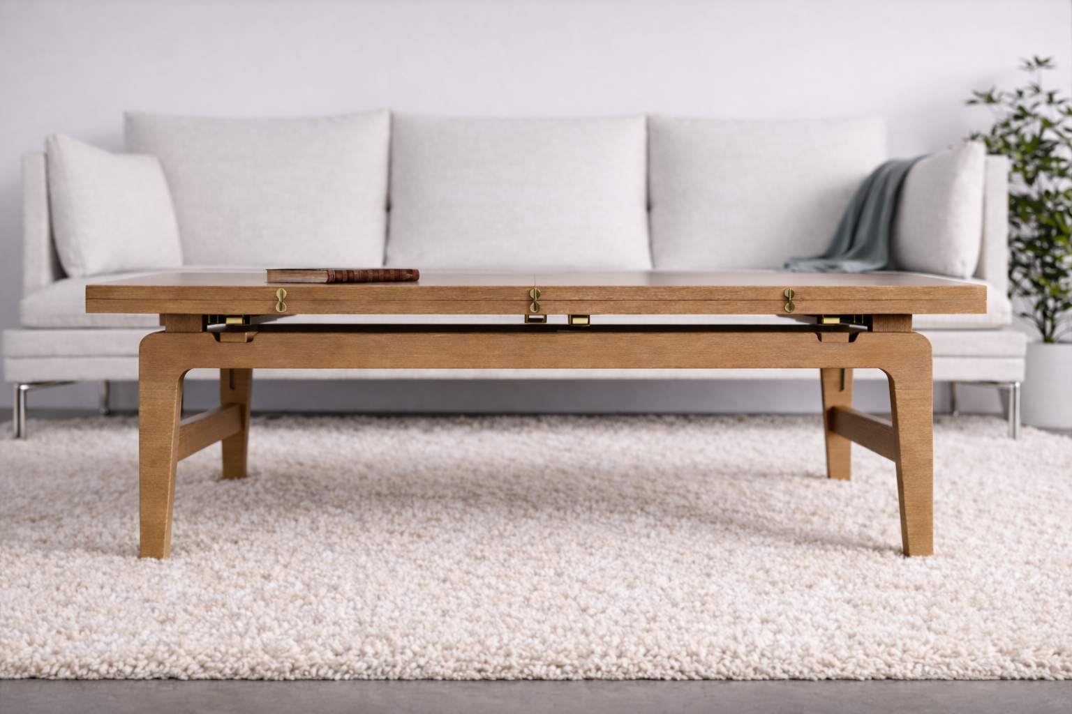Elevator table shown closed in light maple wood, styled as a low table in front of a sofa on a textured rug