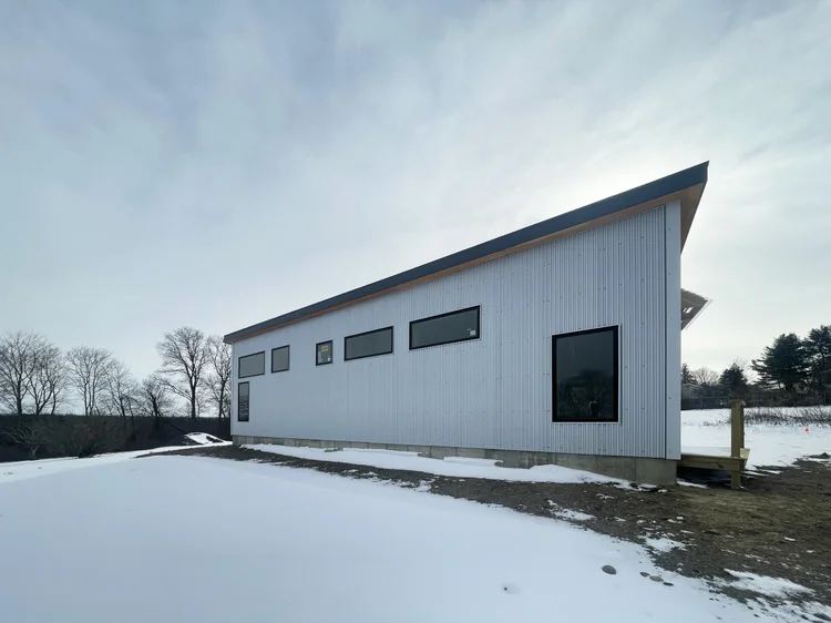 Long shed studio in a snowy field