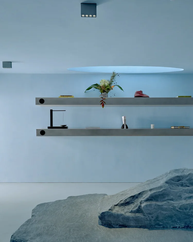 Blue retail interior with steel shelves