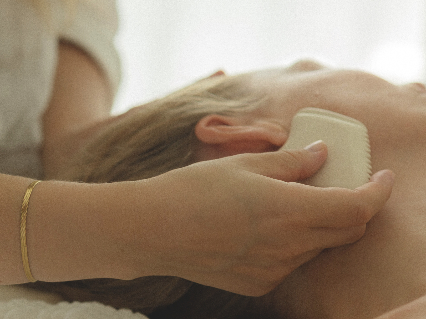 Gua sha behandling i ansikt med lett trykk som jobber med bindevev og sirkulasjon