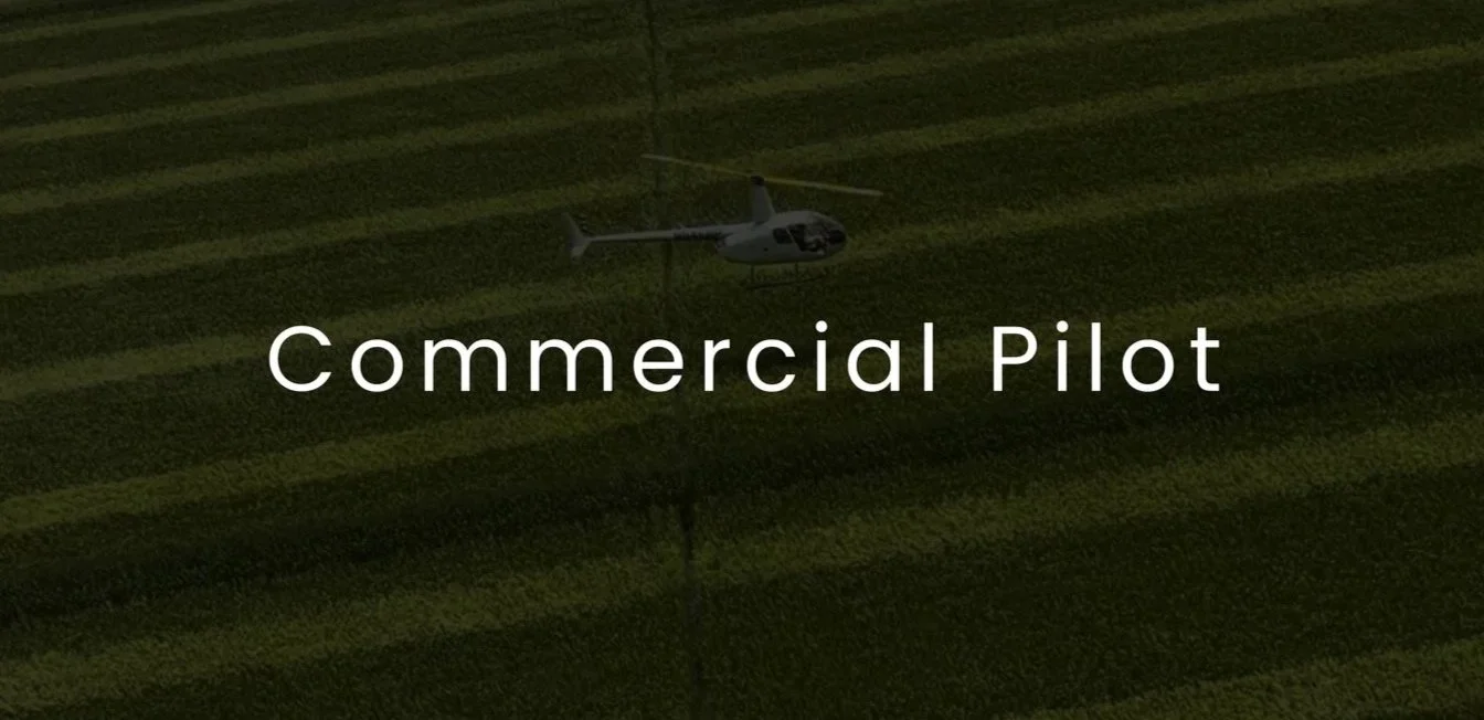 Helicopter flying over a grassy field with parallel lines.