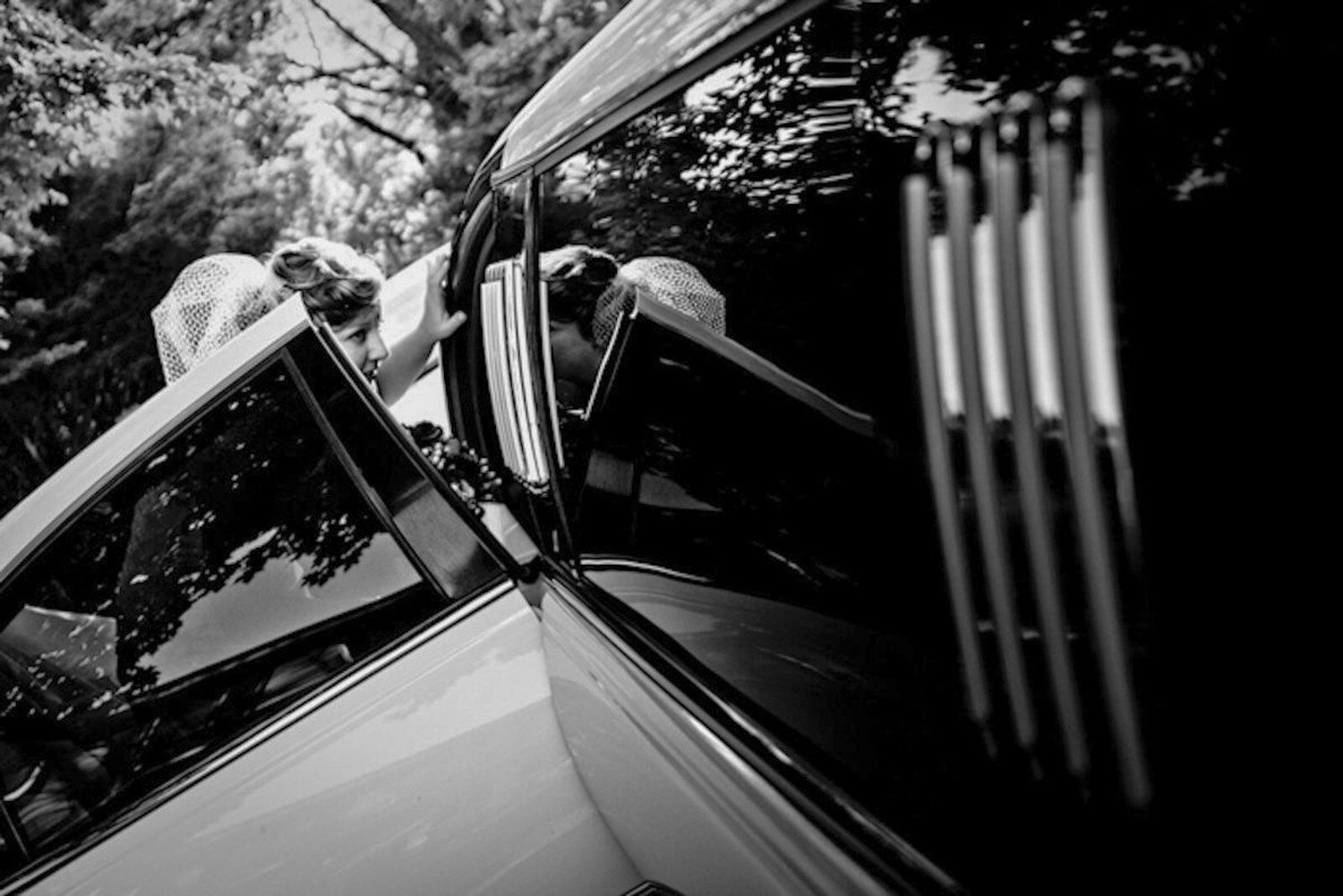 A bride entering a limo during her wedding day.