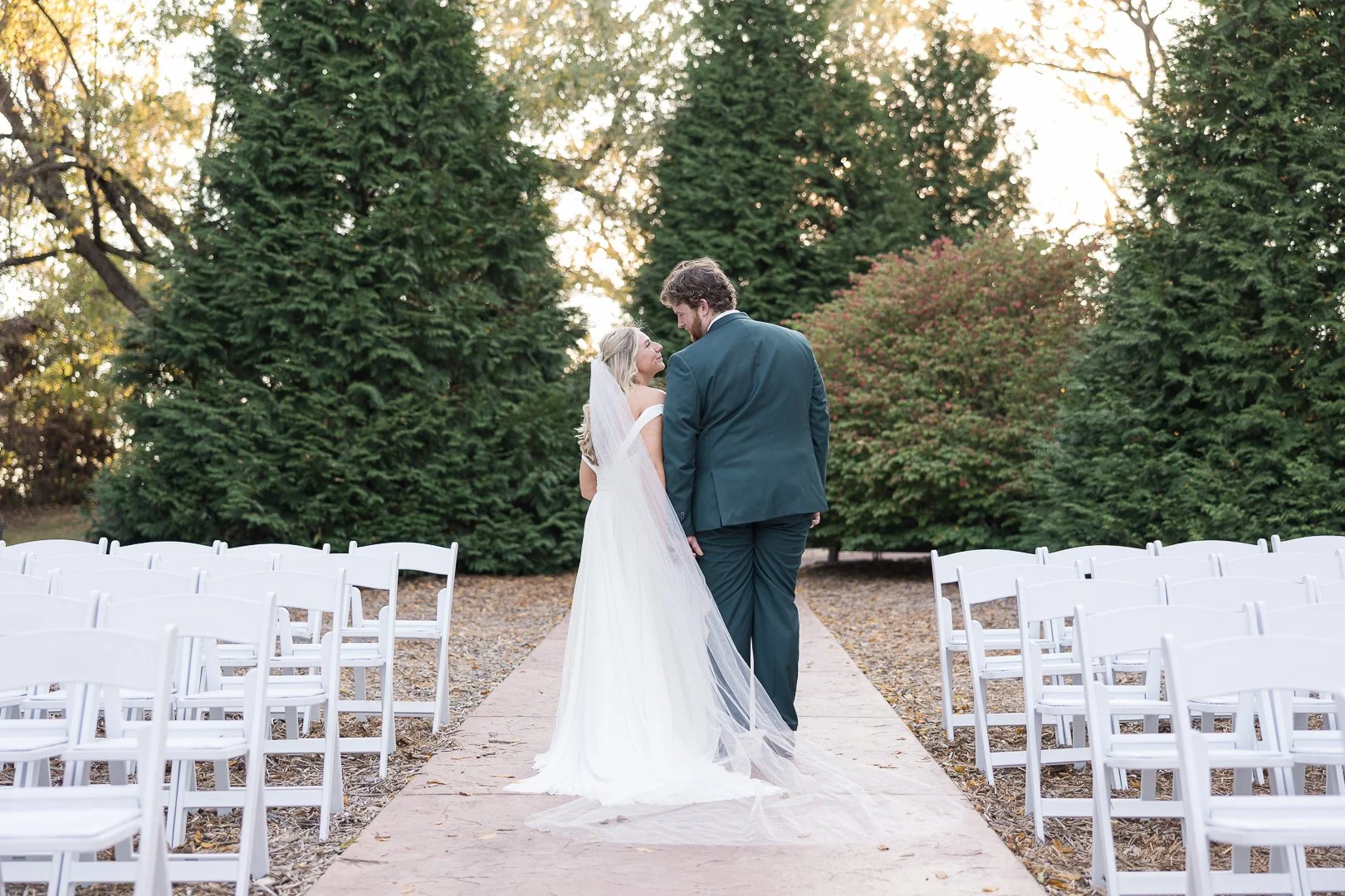Couple stands side by side in golden glow at Samuel Cedars