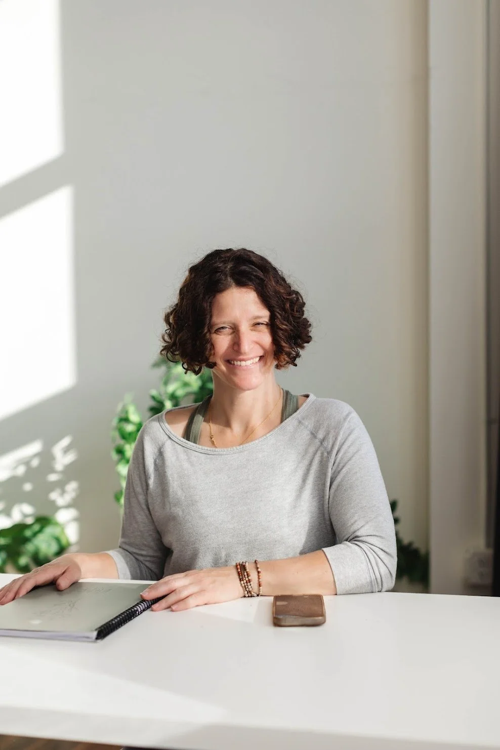 Jenn sits at desk smiling