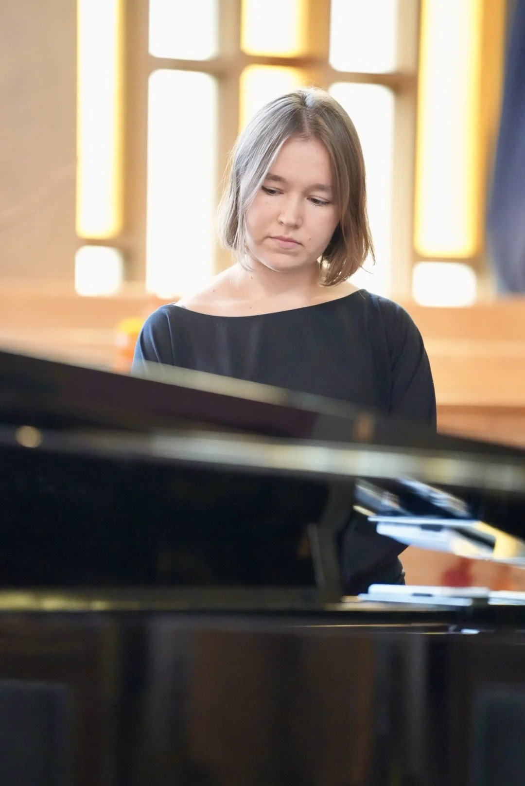 Pianist performing at a grand piano
