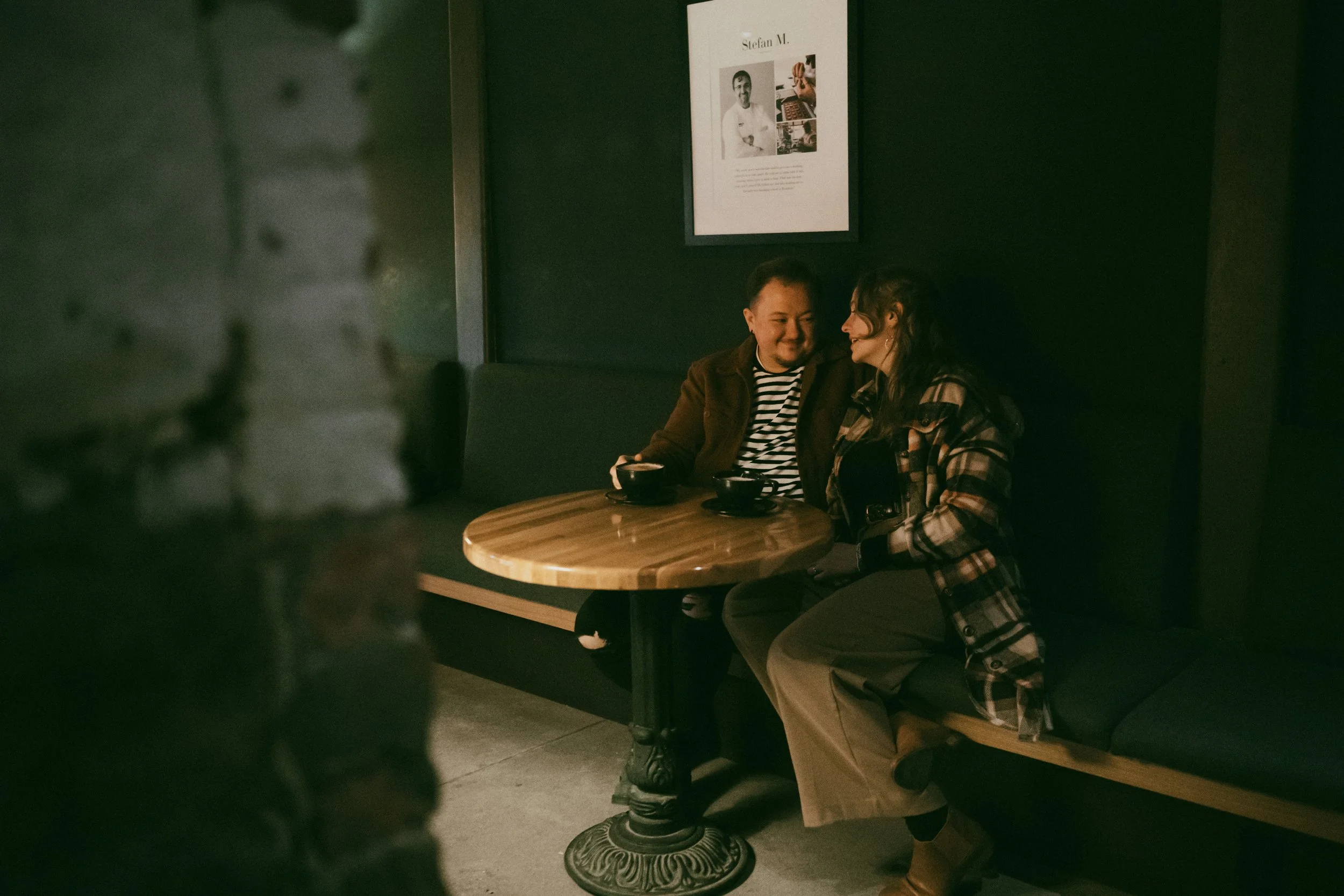couple enjoys a cup of coffee in a dark secluded corner of the Shinola Cafe coffee shop in ann arbor
