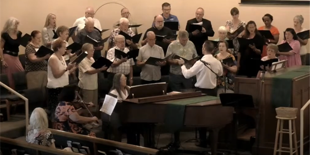 Dr. Klug conducts a choir performance