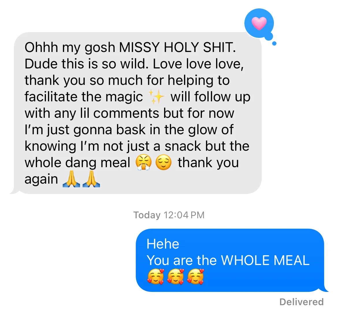 Screenshot of a text message conversation with a loving reply and emojis, including a blue heart and smiling faces.