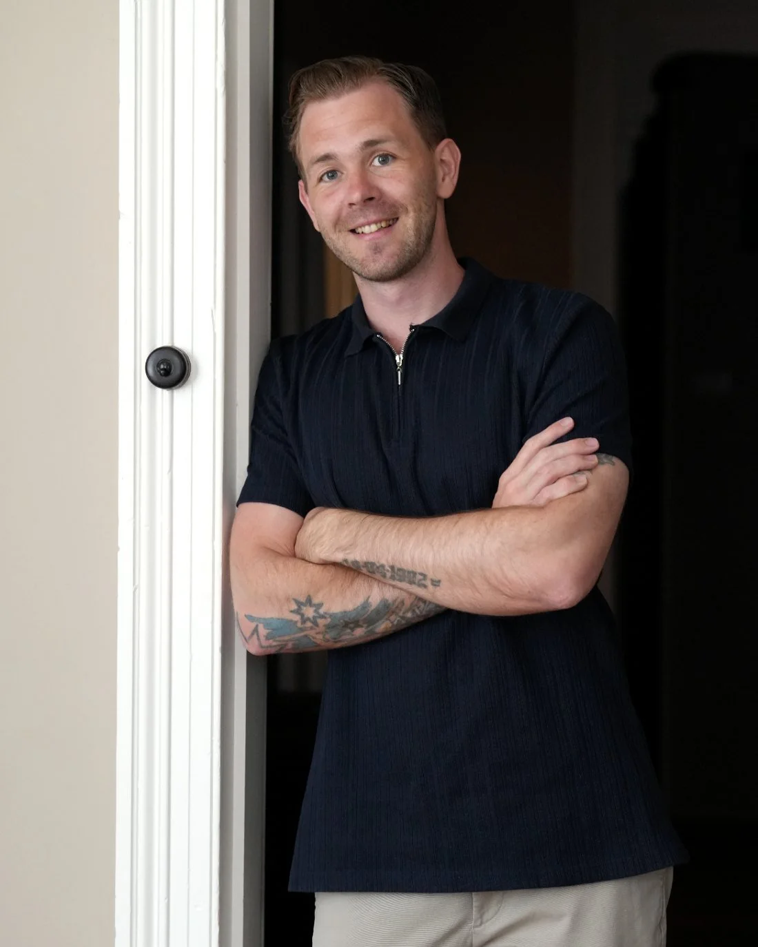 Lucas Lindblom, clinical hypnotherapist, leaning in the doorway of his Thornbury clinic