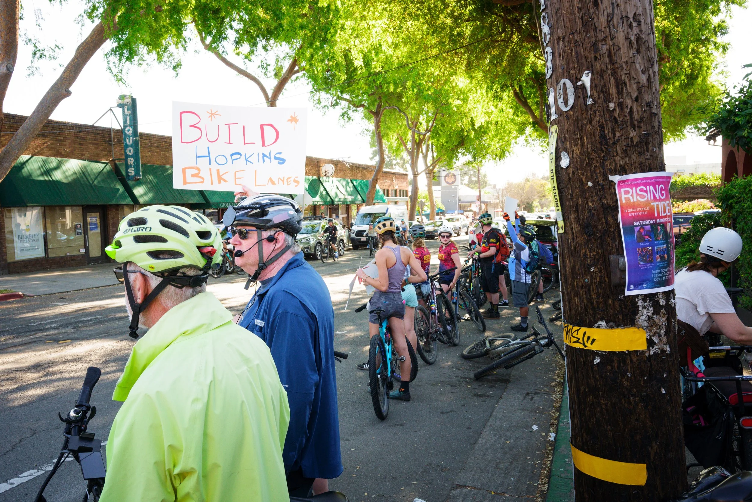 Cyclists line Hopkins Street in Berkeley, CA in support of a project to add a bidirectional cycle track on one side of street, a contentious issue within an aging community worried about preserving parking.