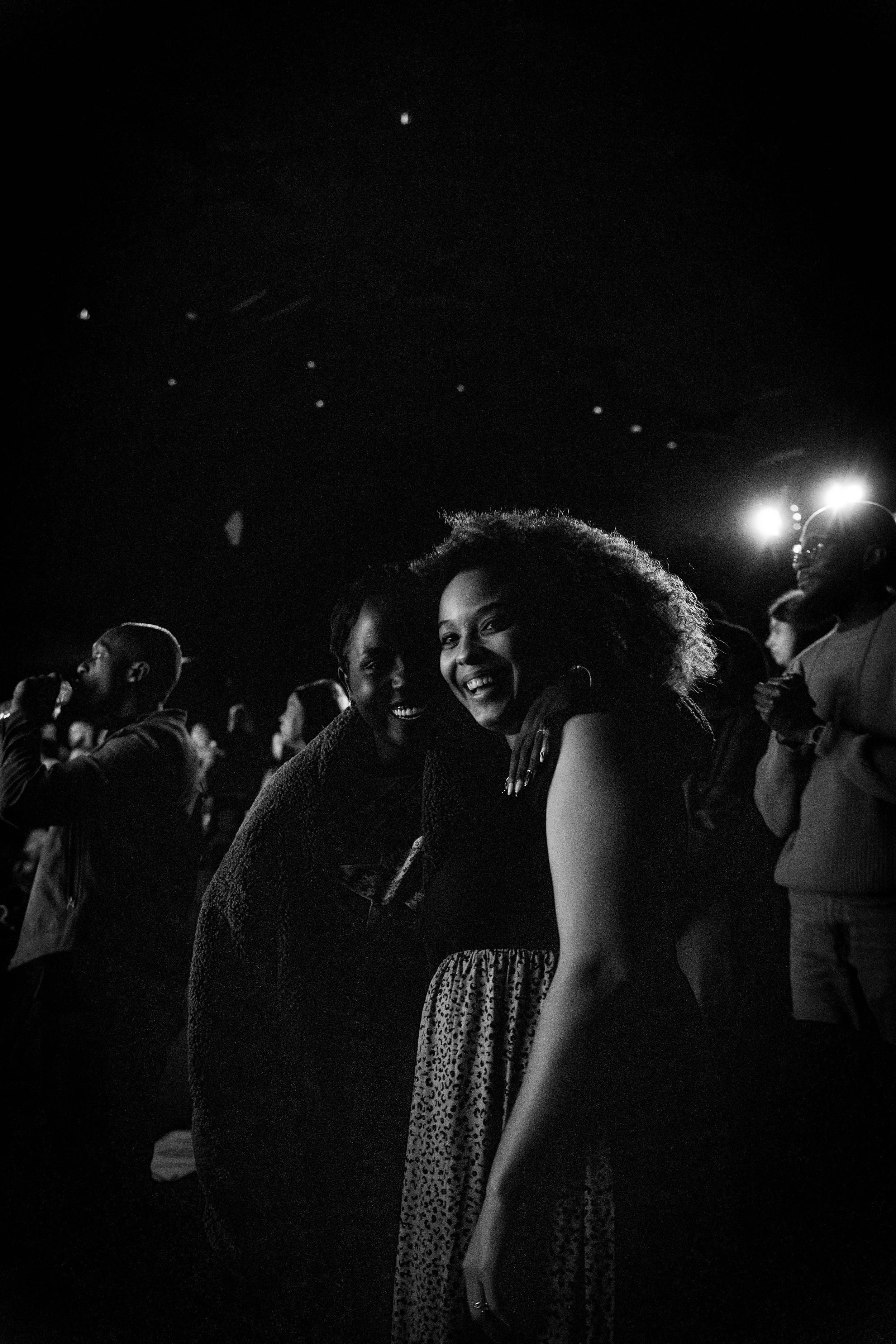 Black-and-white photo of a smiling woman in a crowd during church service