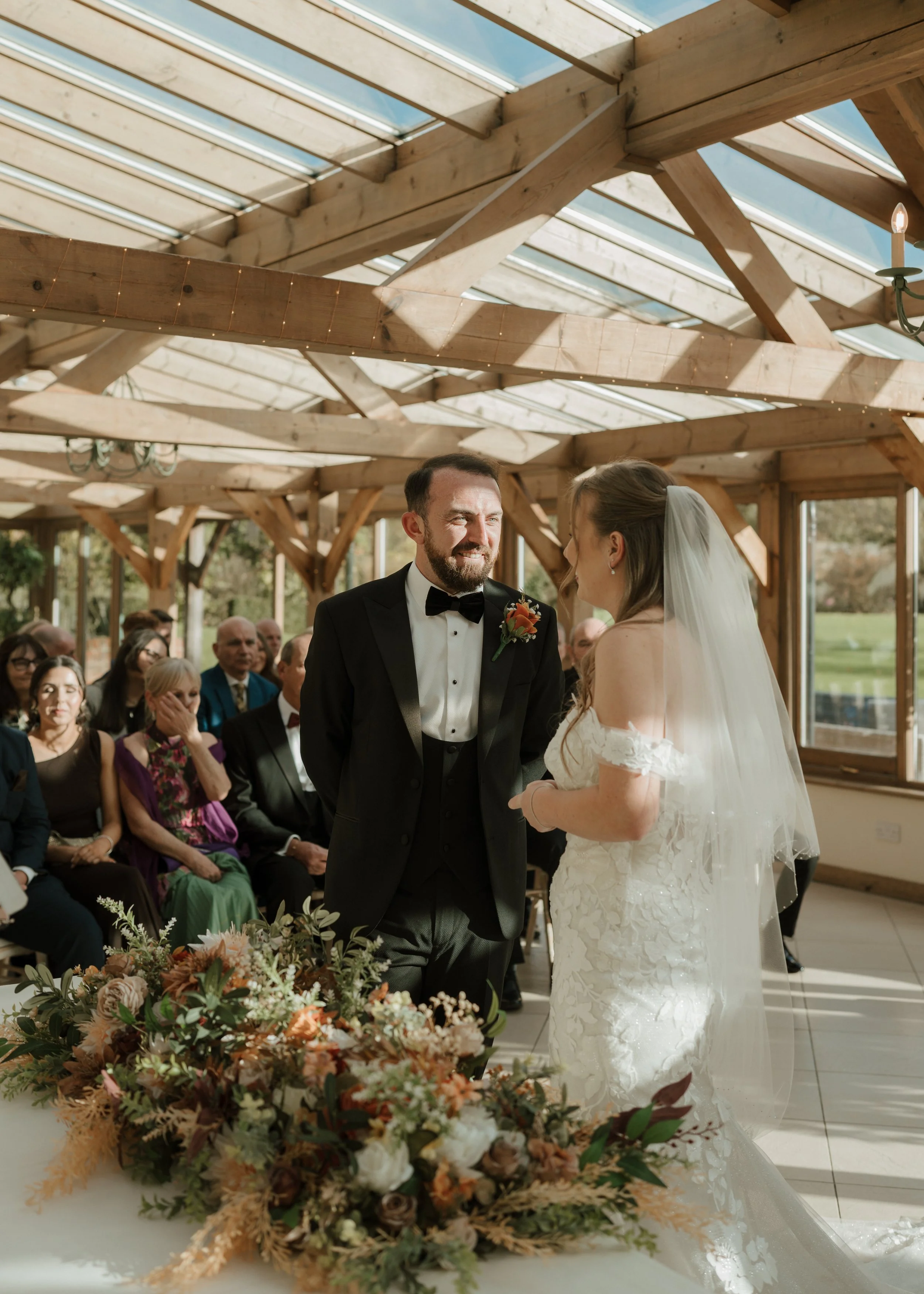 bride and groom laughing during their wedding ceremony at gaynes park in essex