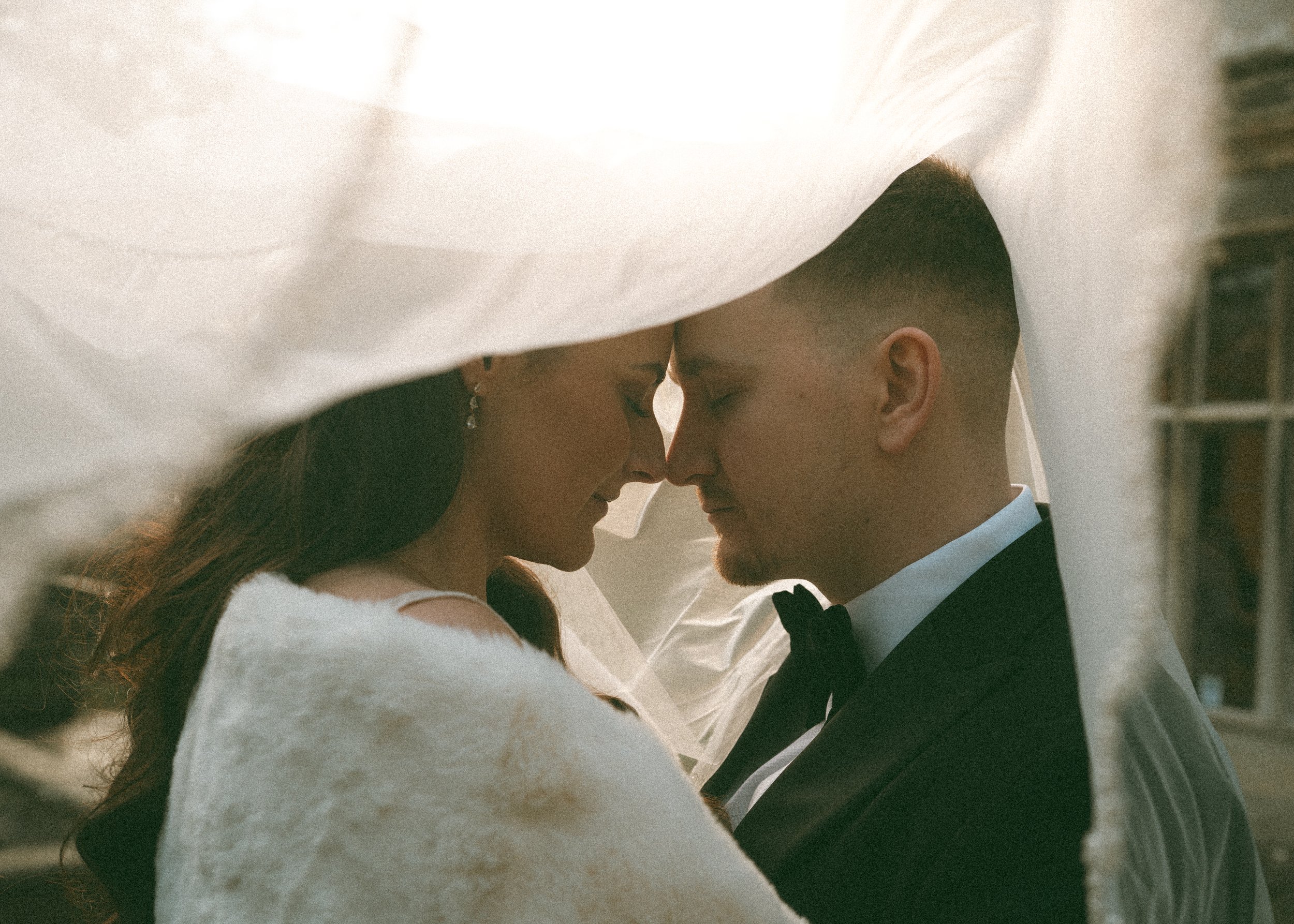 vintage bride and groom under veil in kent