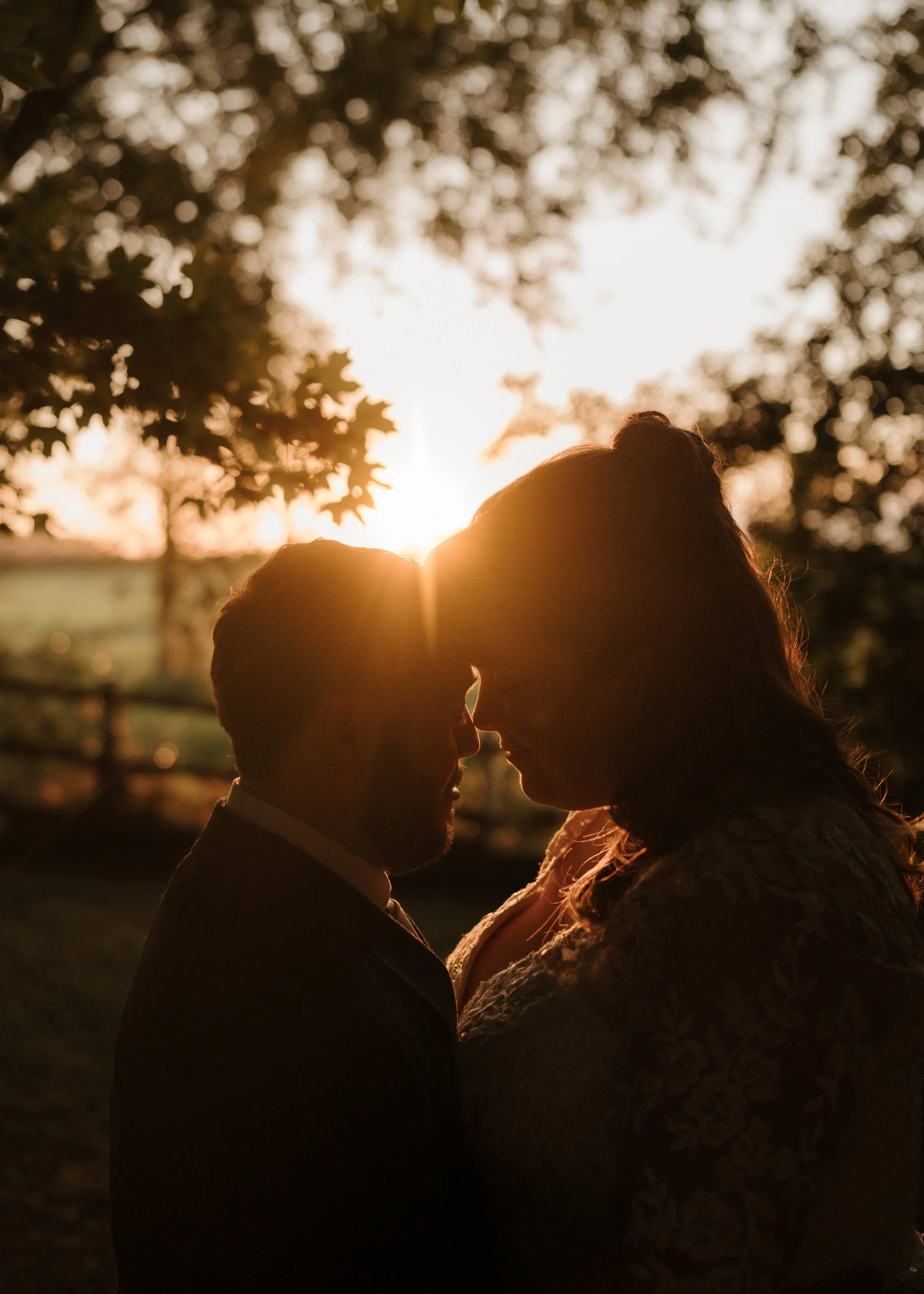 bride and groom sharing a moment during sunset