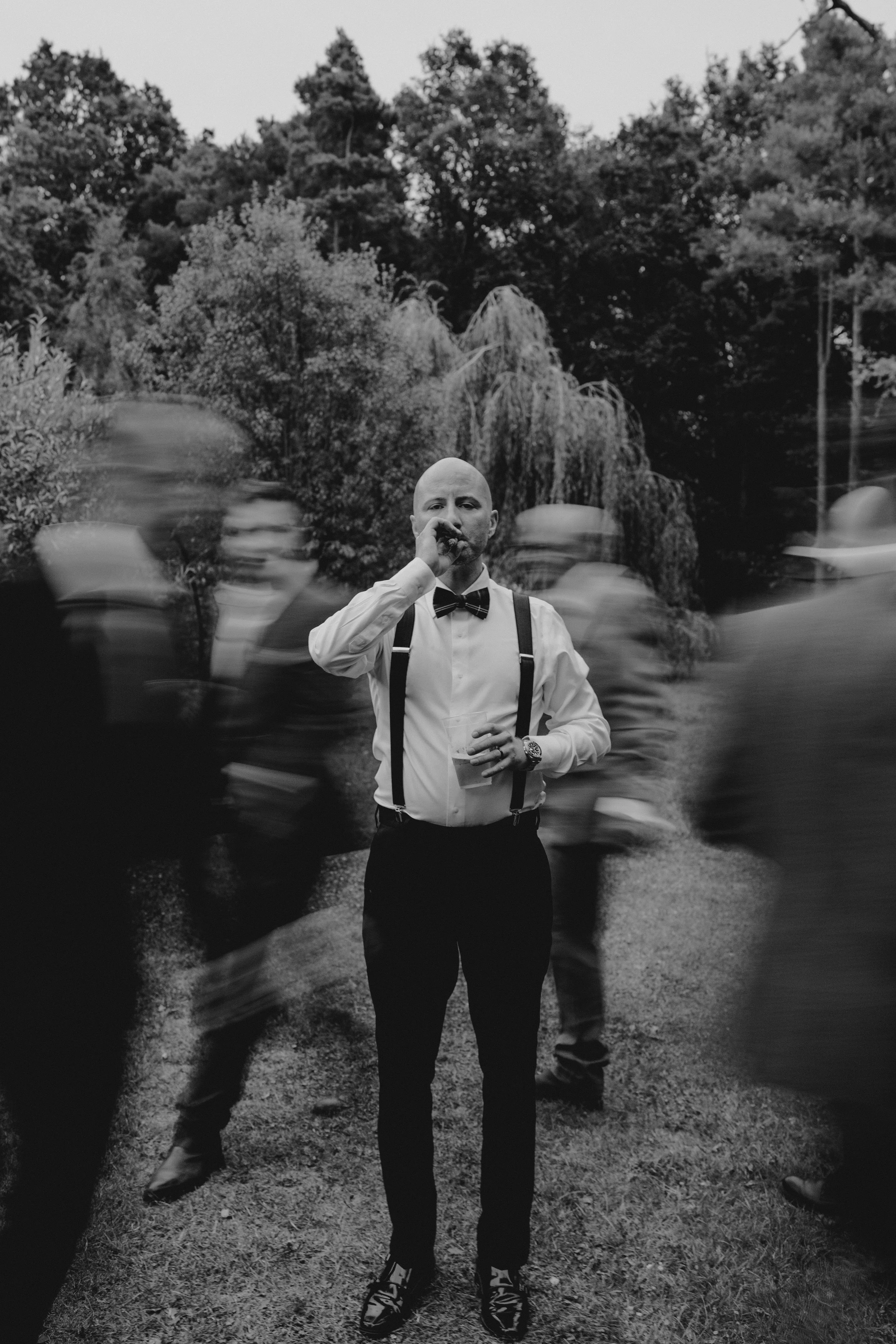 groom standing with a cigar