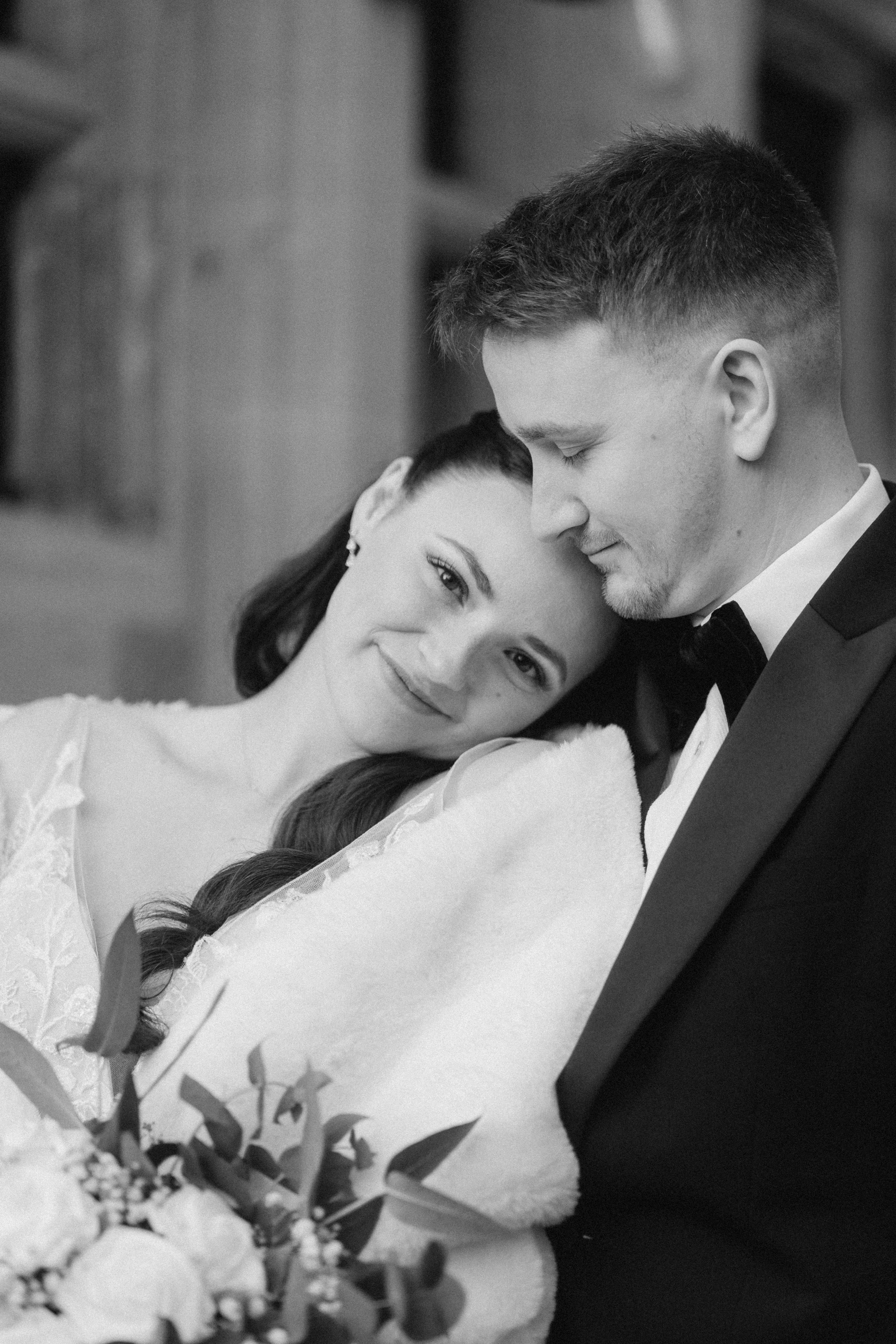 bride laying on grooms shoulder during their couples shoot in eastbourne