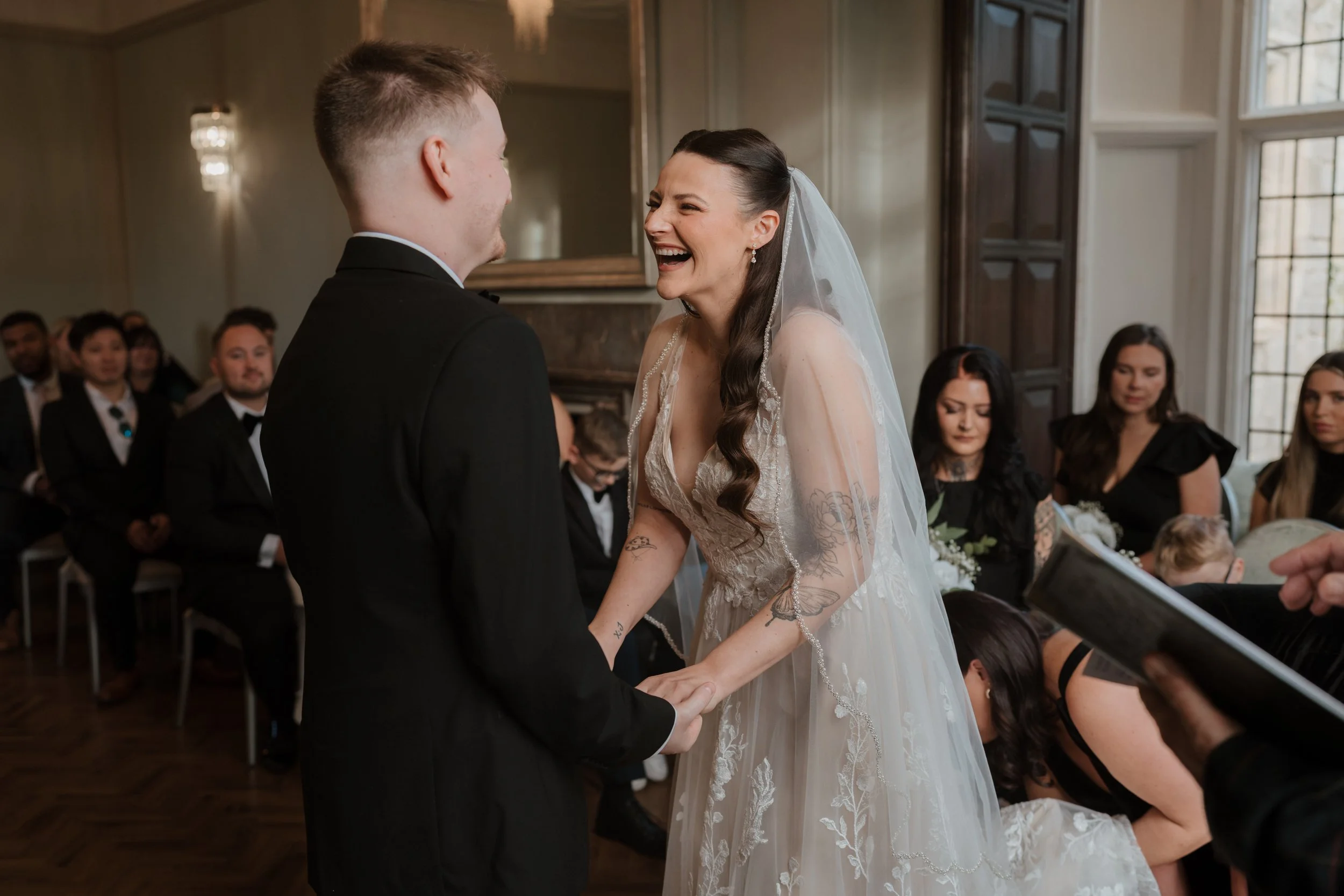 bride and groom laughing to each other during their wedding ceremony in bury st edmunds suffolk