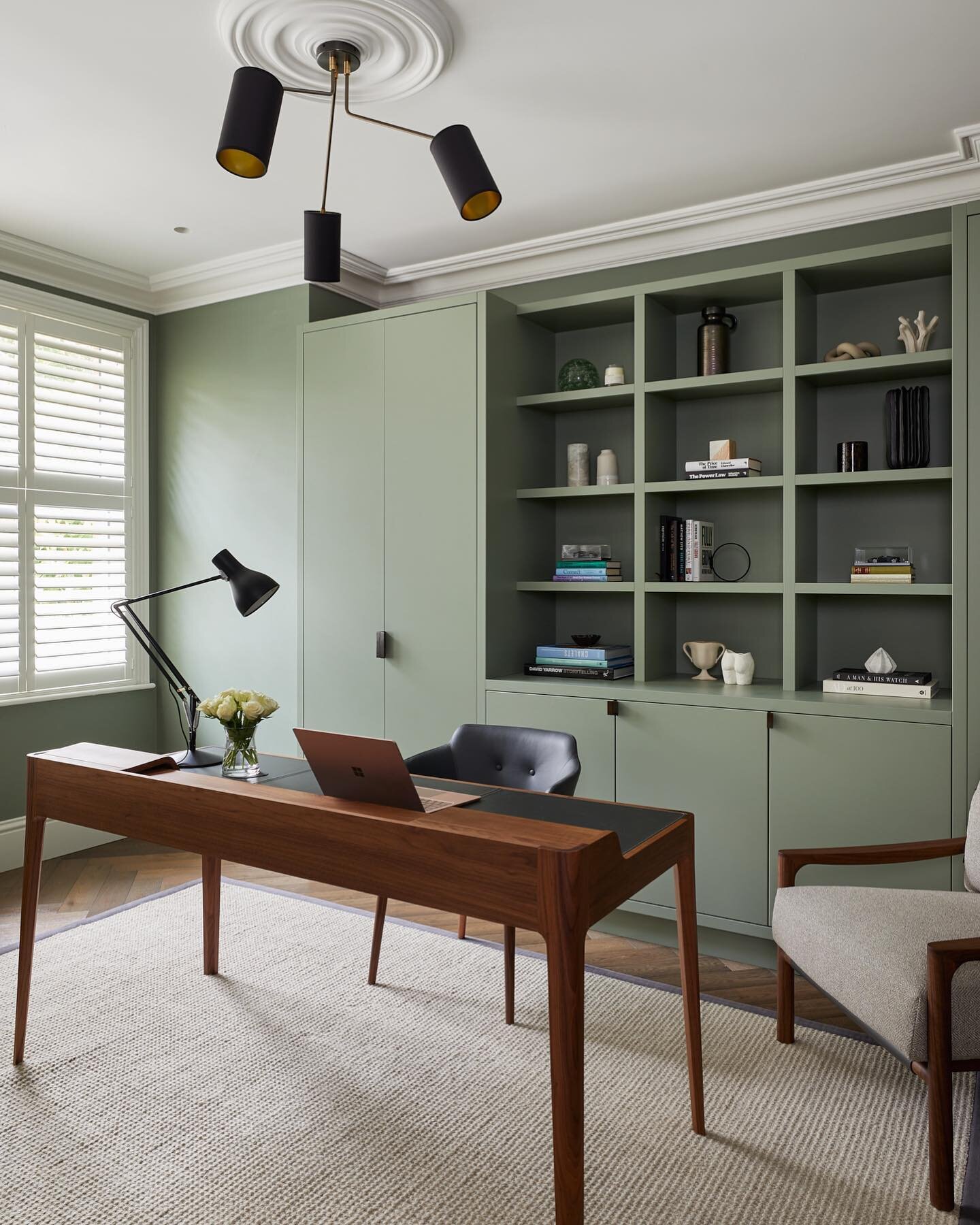 We meticulously plan all our designs down to the nth degree. In this home office, there are no trailing wires thanks to a hollow desk leg, a carefully positioned hole in the rug and and floor sockets. 

The doors of the tall joinery unit slide back t