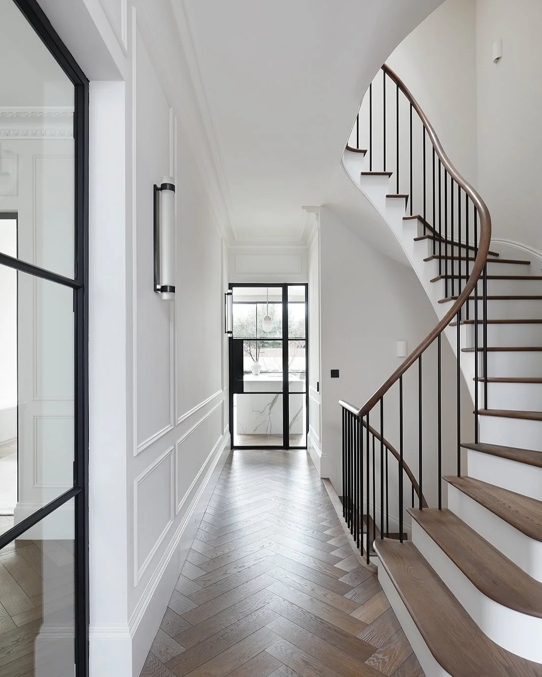 First impressions count. Here are 5 ways we created a beautiful, welcoming entrance hall in our Wandsworth project.

1. A glazed door to the kitchen allows views straight through to the garden upon entering the house.
It really opens up the space.

2