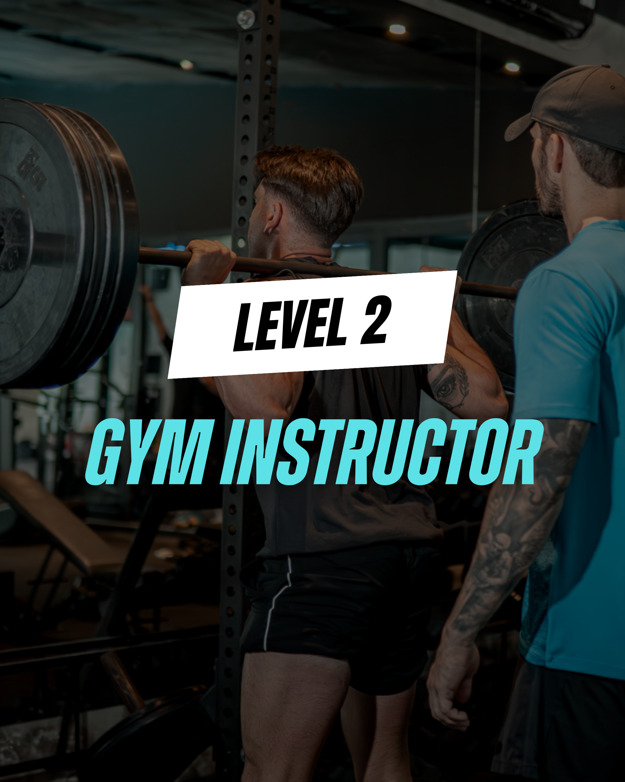 Two men in a gym near exercise equipment, with one with tattoos and baseball cap, the other with short brown hair, lifting a barbell.