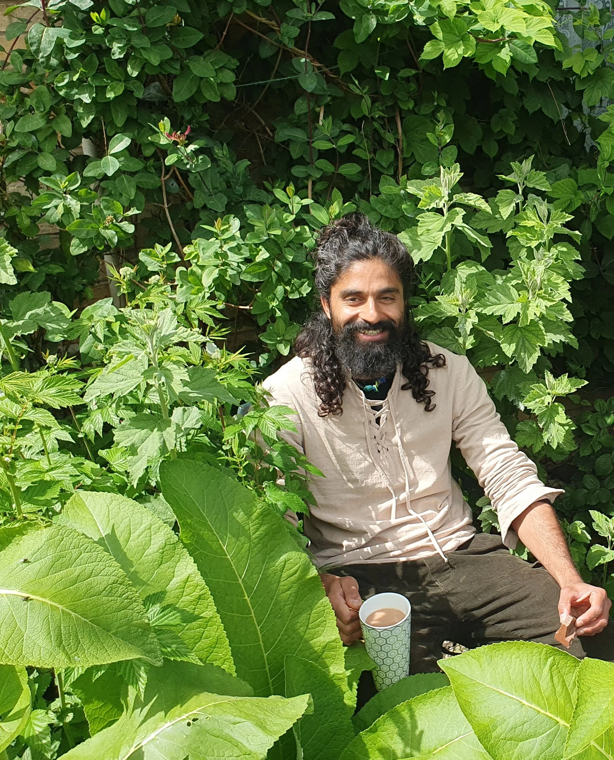 Muji sits is one of the medicinal forest gardens he created over 8 years ago