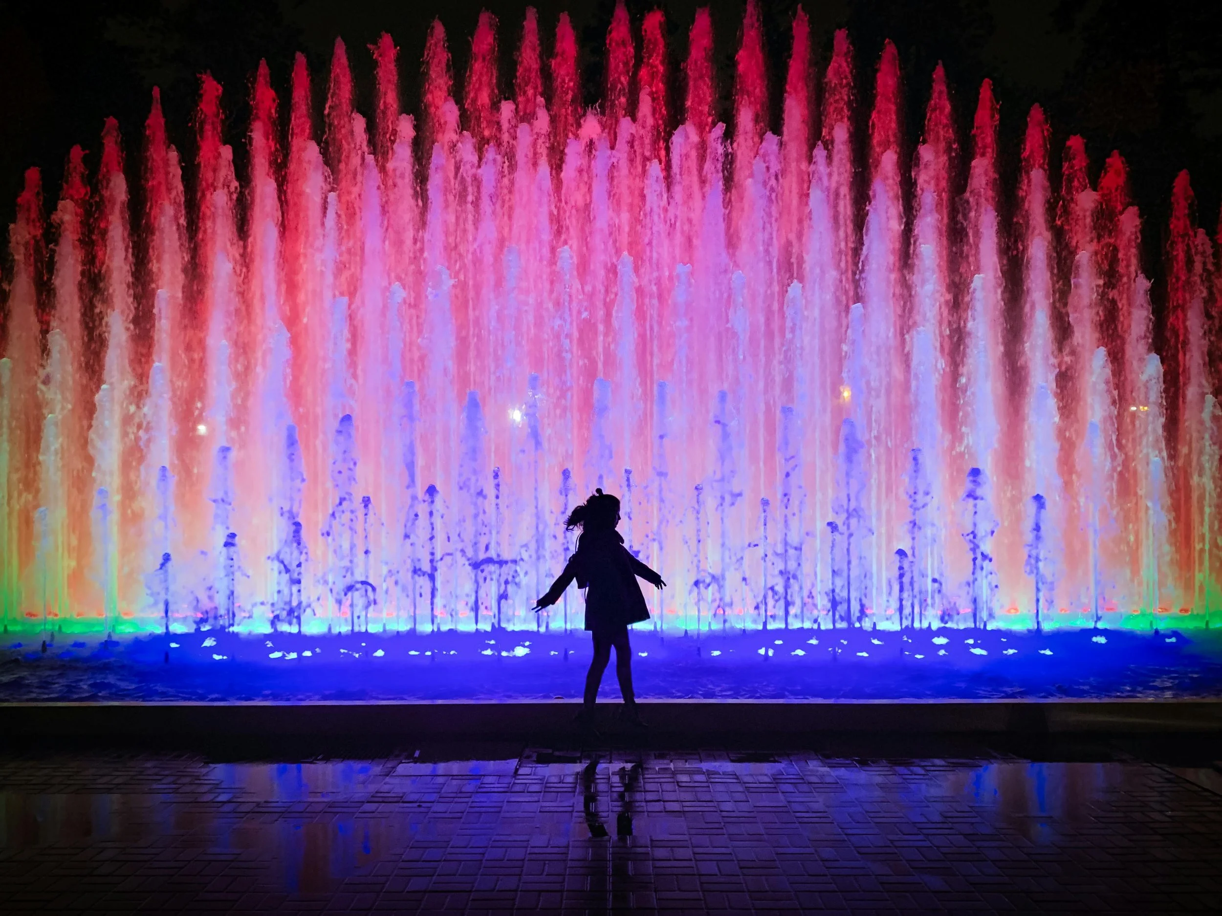 Nonprofit Futures Substack Cover of girl dancing in front of lighted fountain