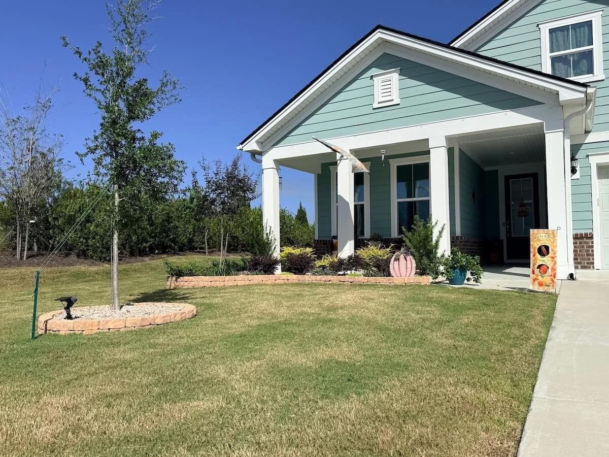 Beautifully designed garden beds showing lowcountry-friendly shrubs and plants and stylish stone irrigation walls.