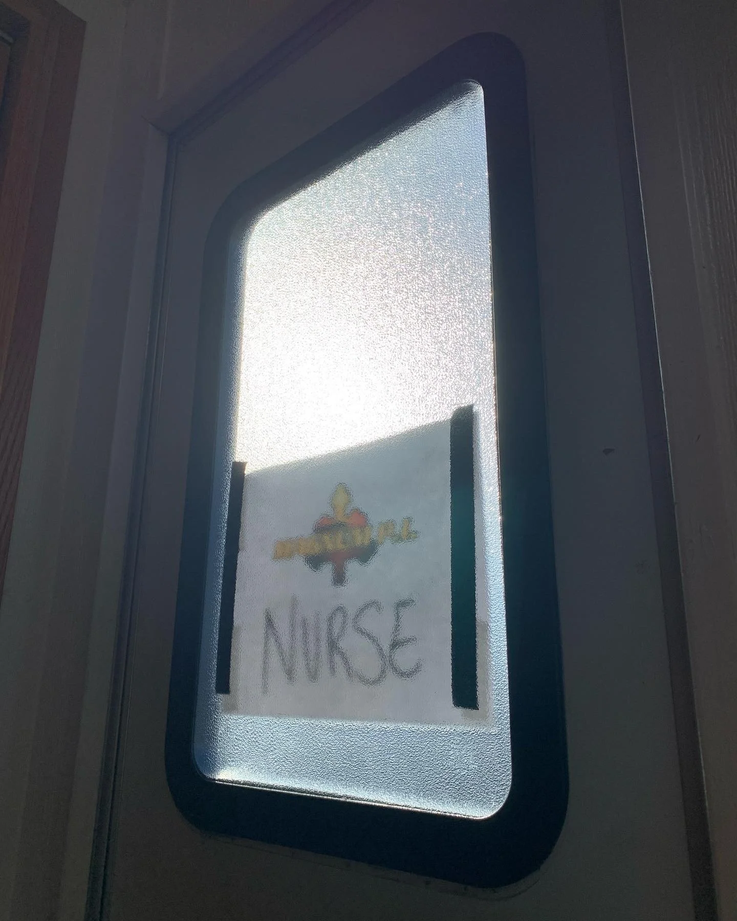 On set filming for MAGNUM P.I. with CBS on the studio lot. Frosted glass door with a sign that has a logo and the word 'NURSE' visible. Recurring role.