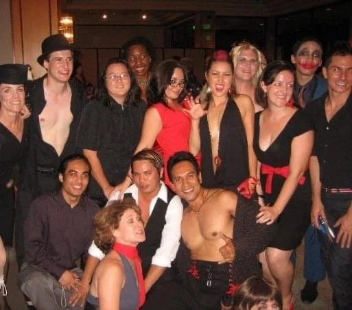 ROCKY HORROR SHOW AT Manoa Valley Theatre. Actress Cassie Favreau-Chung plays Magenta. Pookela Awards in Hawaii. Performers and friends celebrating at an indoor event, with some dressed as clowns and others in costumes, smiling at the camera.