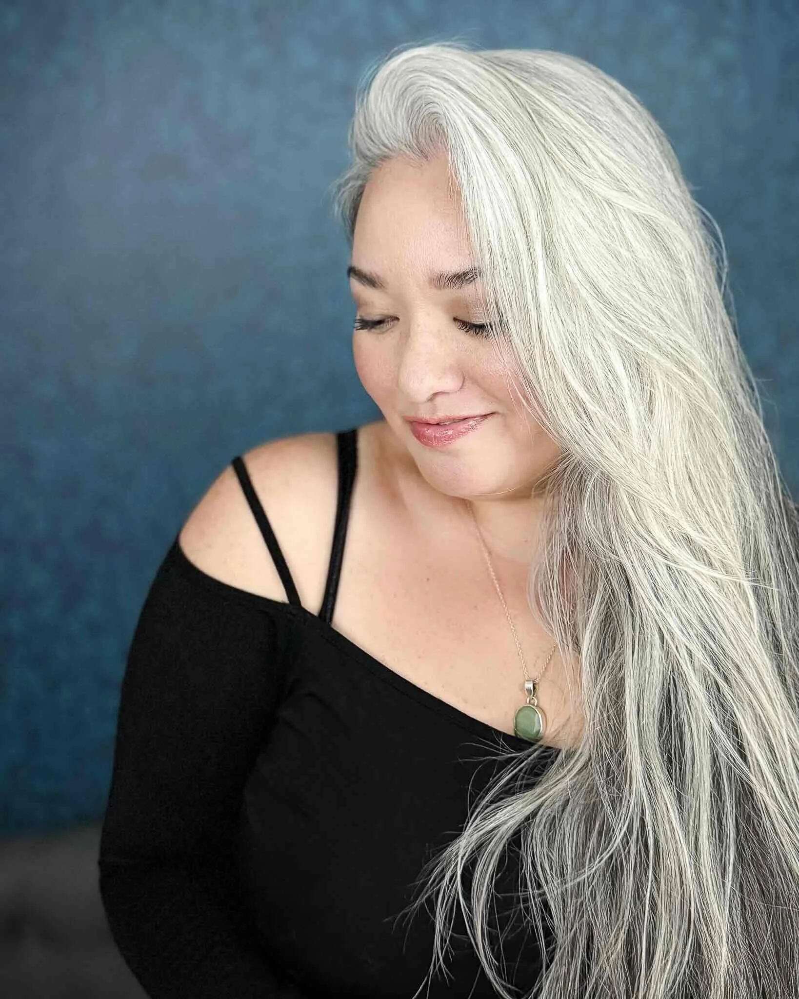 SAG-AFTRA actress and singer, Cassie Favreau-Chung, during a studio shoot with vintage teal wallpaper. Based in Honolulu, Hawaii.