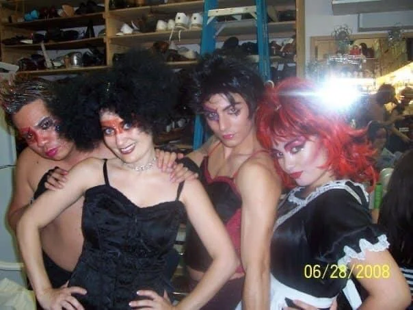 ROCKY HORROR SHOW AT Manoa Valley Theatre. Actress Cassie Favreau-Chung plays Magenta. Four people dressed as the characters from The Addams Family in a room filled with shelves of shoes and accessories.