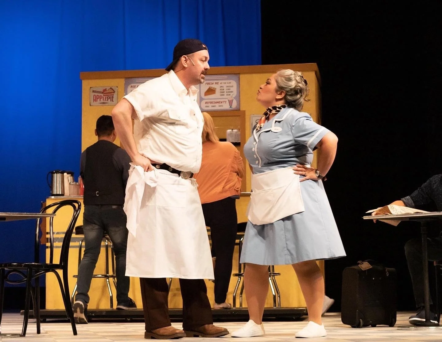 Scene from WAITRESS the Broadway musical by Sara Bareilles at Diamond Head Theatre. Becky and Cal arguing in the diner. Cassie Favreau-Chung (Becky) and Don Farmer (Cal). "Opening Up" song.