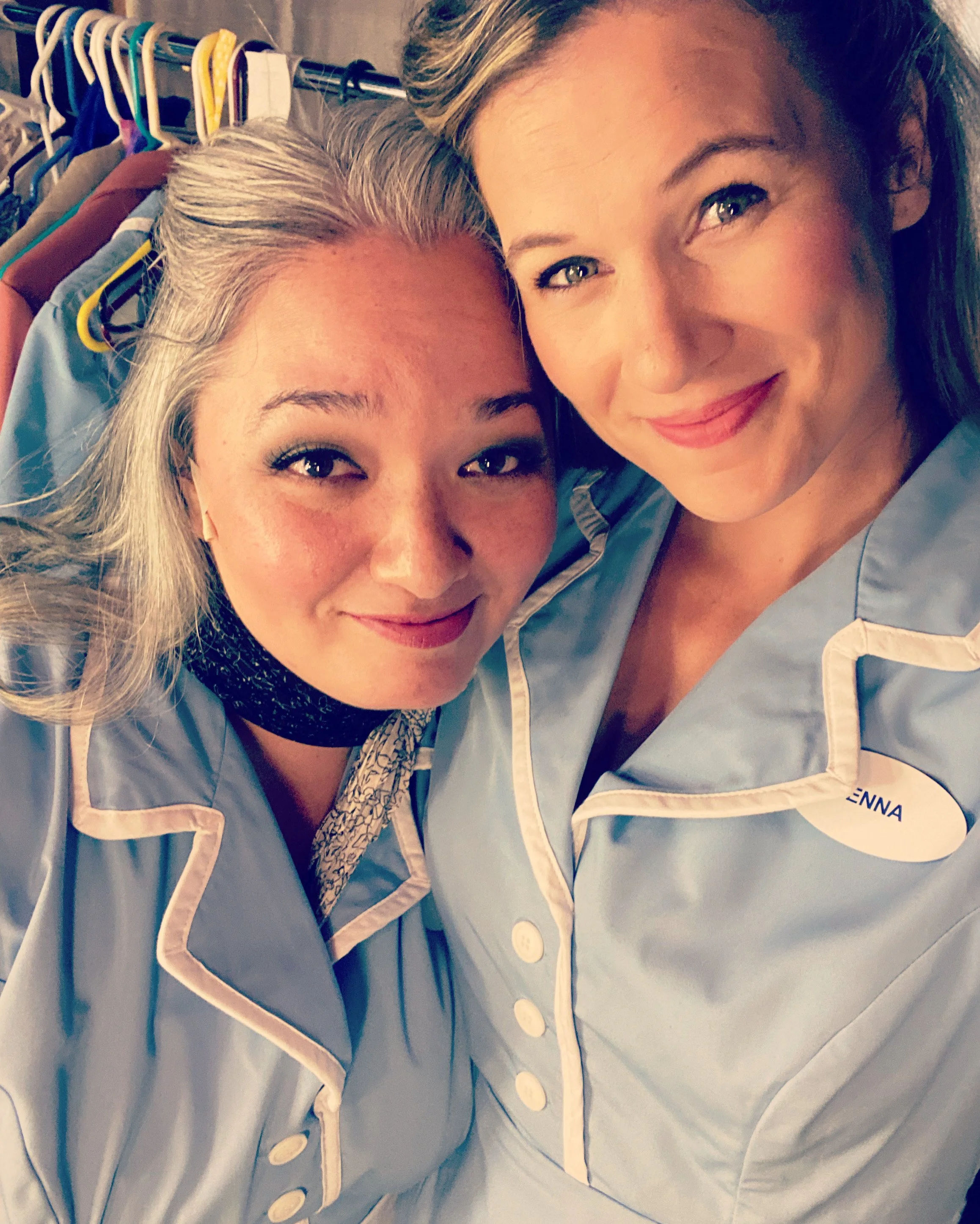 WAITRESS the Broadway musical by Sara Bareilles at Diamond Head Theatre in Honolulu, Hawaii. Becky and Jenna. Blue waitress outfits with name tags. Backstage with clothing racks full of costumes.