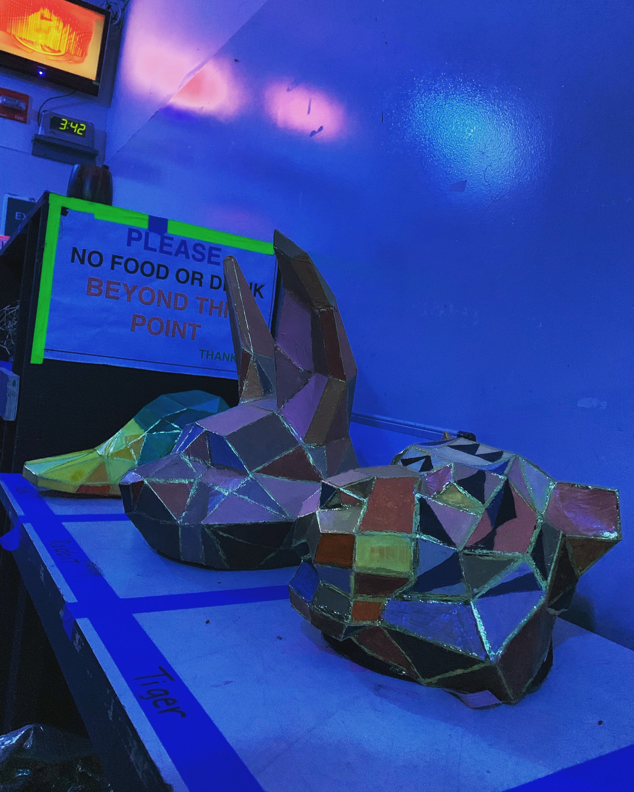 CHILDREN OF EDEN a Broadway musical by I'm A Bright Kid Foundation at Paliku Theatre. Colorful, geometric-style sculpture of a rabbit lying on a table in a room illuminated with blue and purple lights.