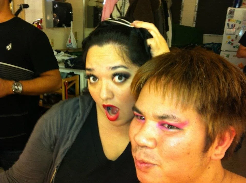 LITTLE SHOP OF HORRORS a comedic musical at Manoa Valley Theatre in Honolulu, Hawaii. Two people with bold makeup taking a selfie in a room, with one person's hand on the other's head.