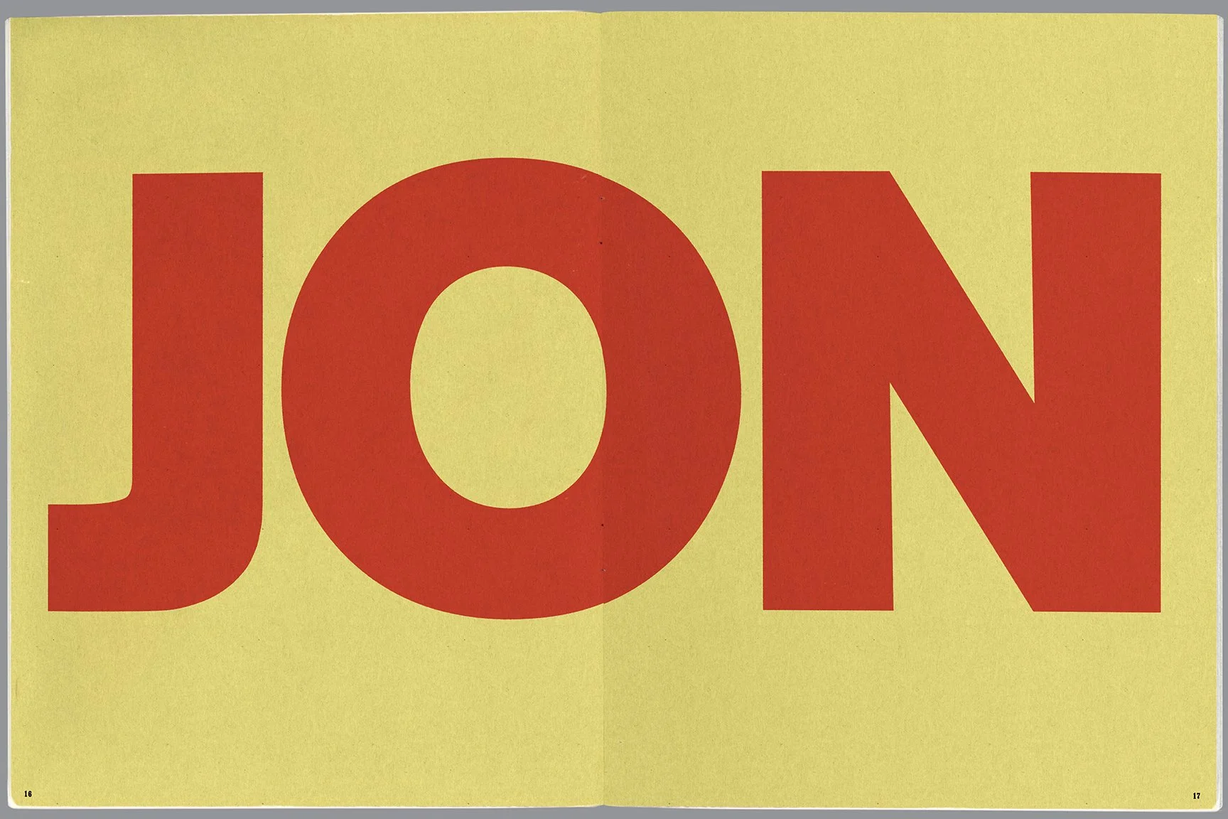 Close-up of a yellow sign with the red word "JON" in large block letters.