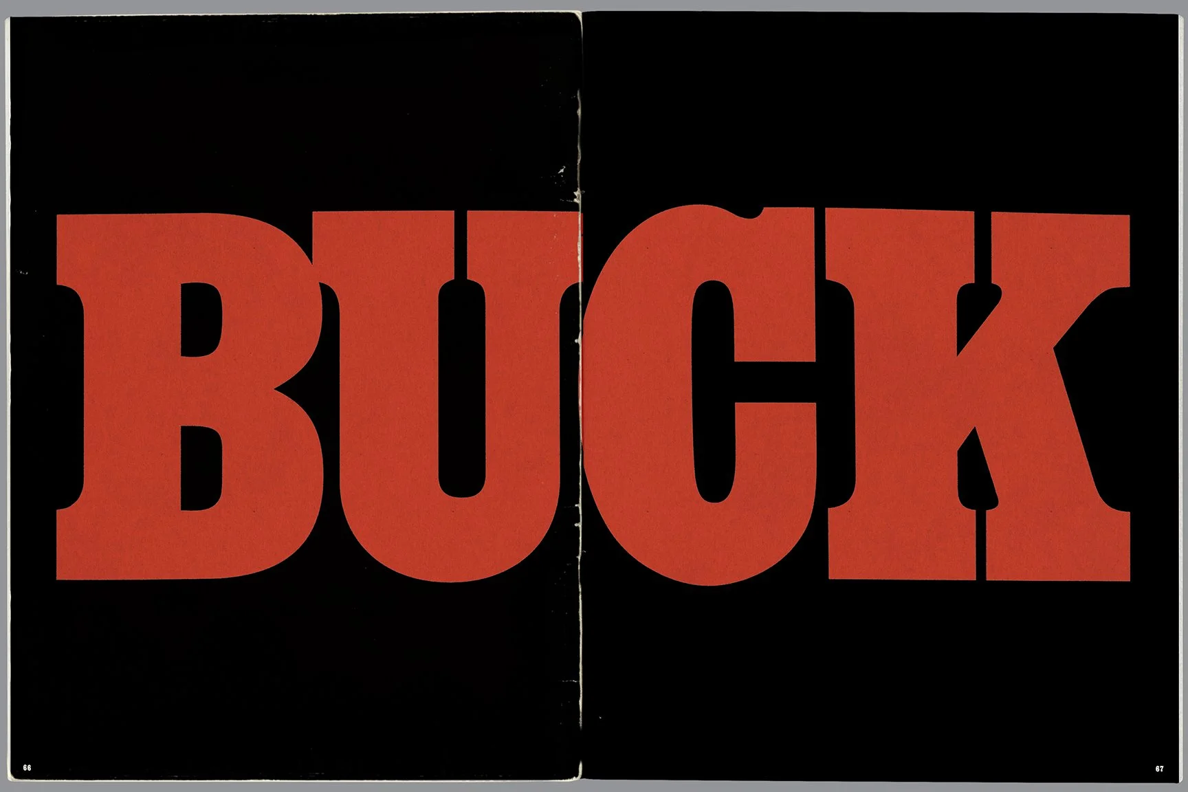 Close-up of a black background with large, bold, red-orange letters spelling ZIP, covering both pages of an open book or magazine.