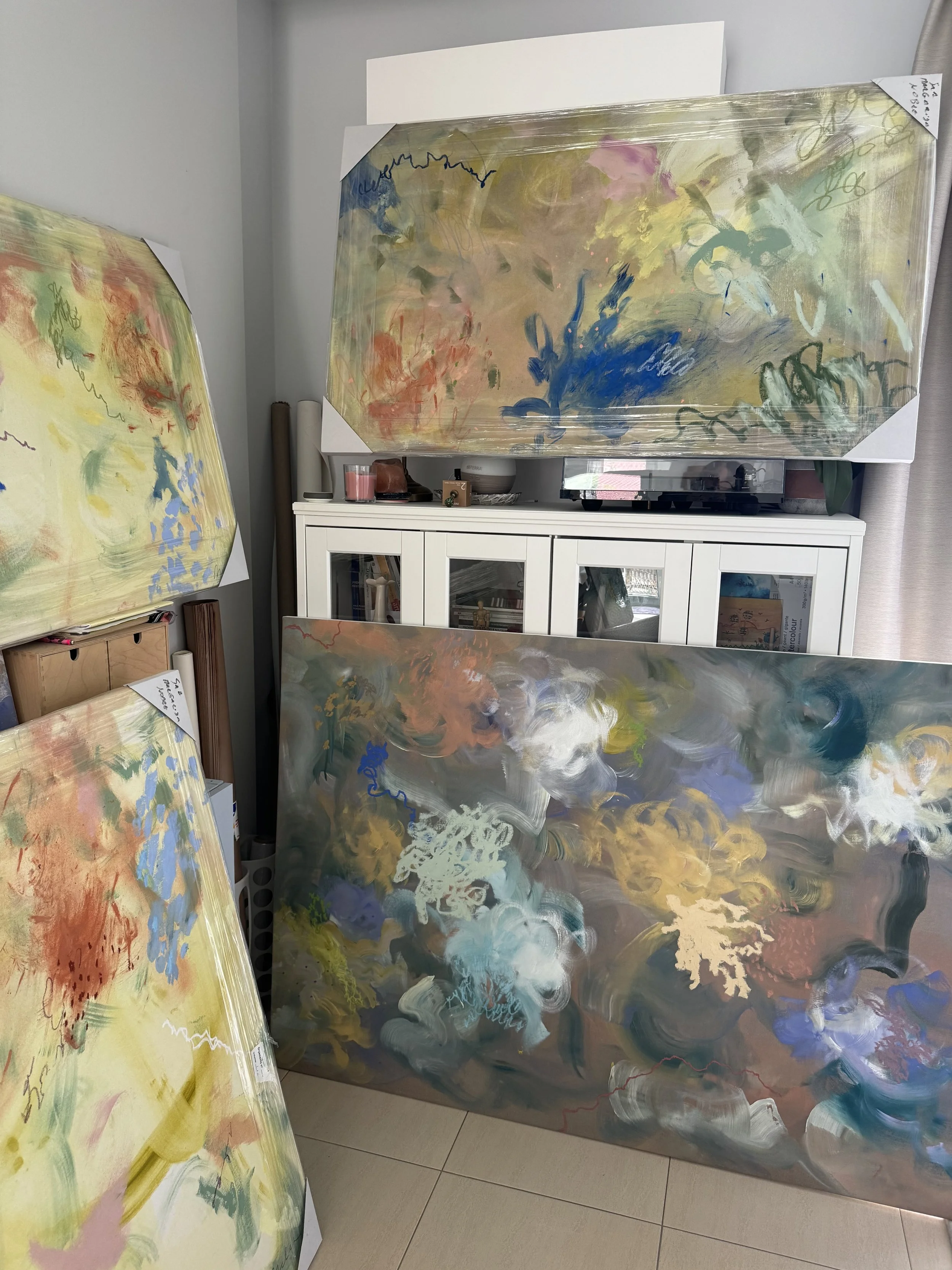 Expirare I, ochre and cobalt blue abstract painting by Margarida Nobre, shown in a living room