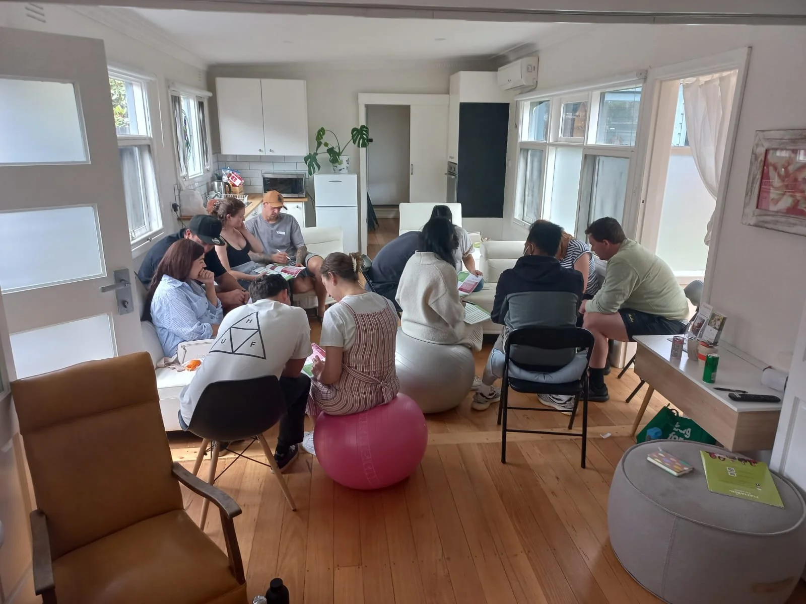 Expectant parents of diverse ages and backgrounds taking notes in a MAMA Birth Class.