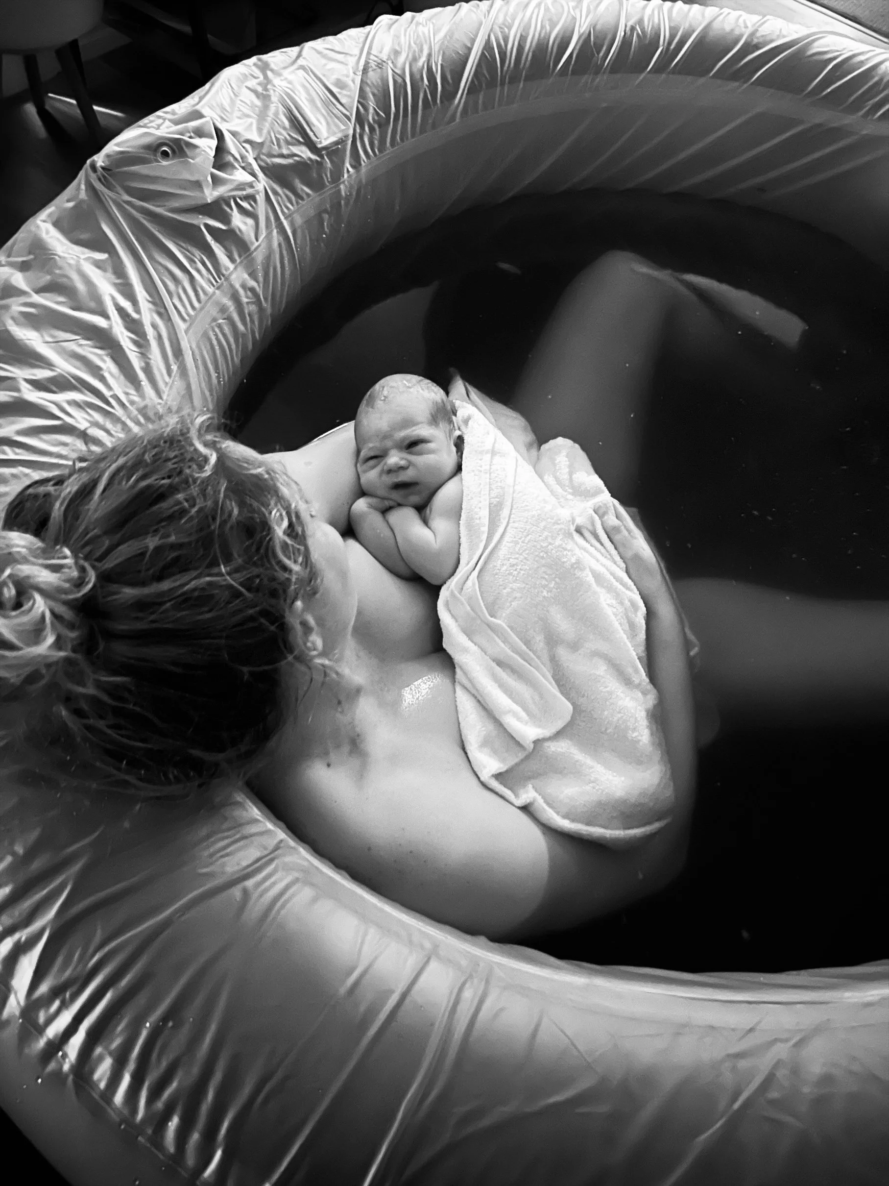 Mother and baby in birth pool after empowering home birth