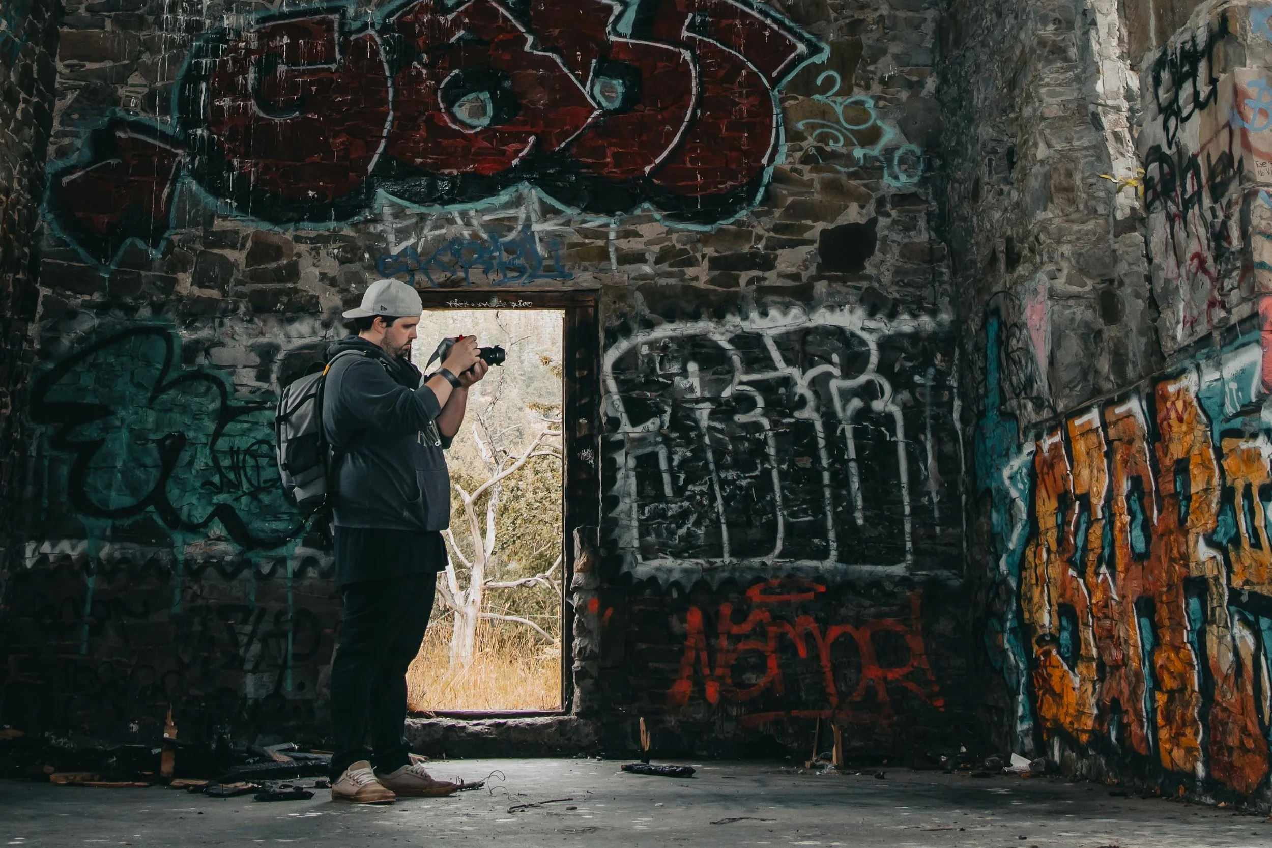 a man taking photographs of the interior graffiti butter stone church Duncan British Columbia, Dylan Phillips Photography