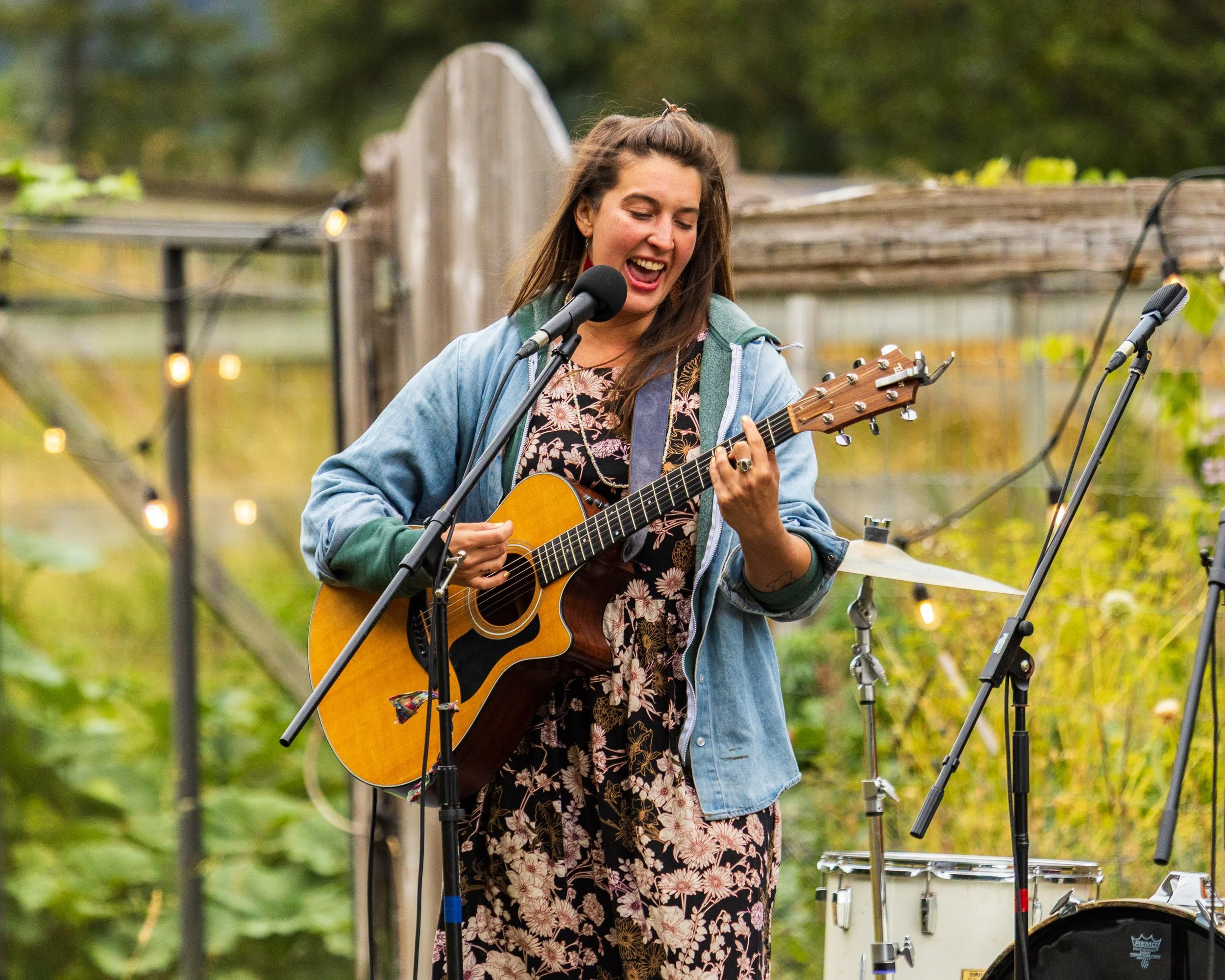 Portrait of a woman singing and playing acoustic guitar at an outdoor event - Dylan Phillips Photography, Vancouver Island B.C